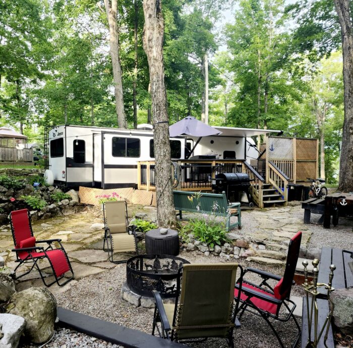 private wooded site with trailer