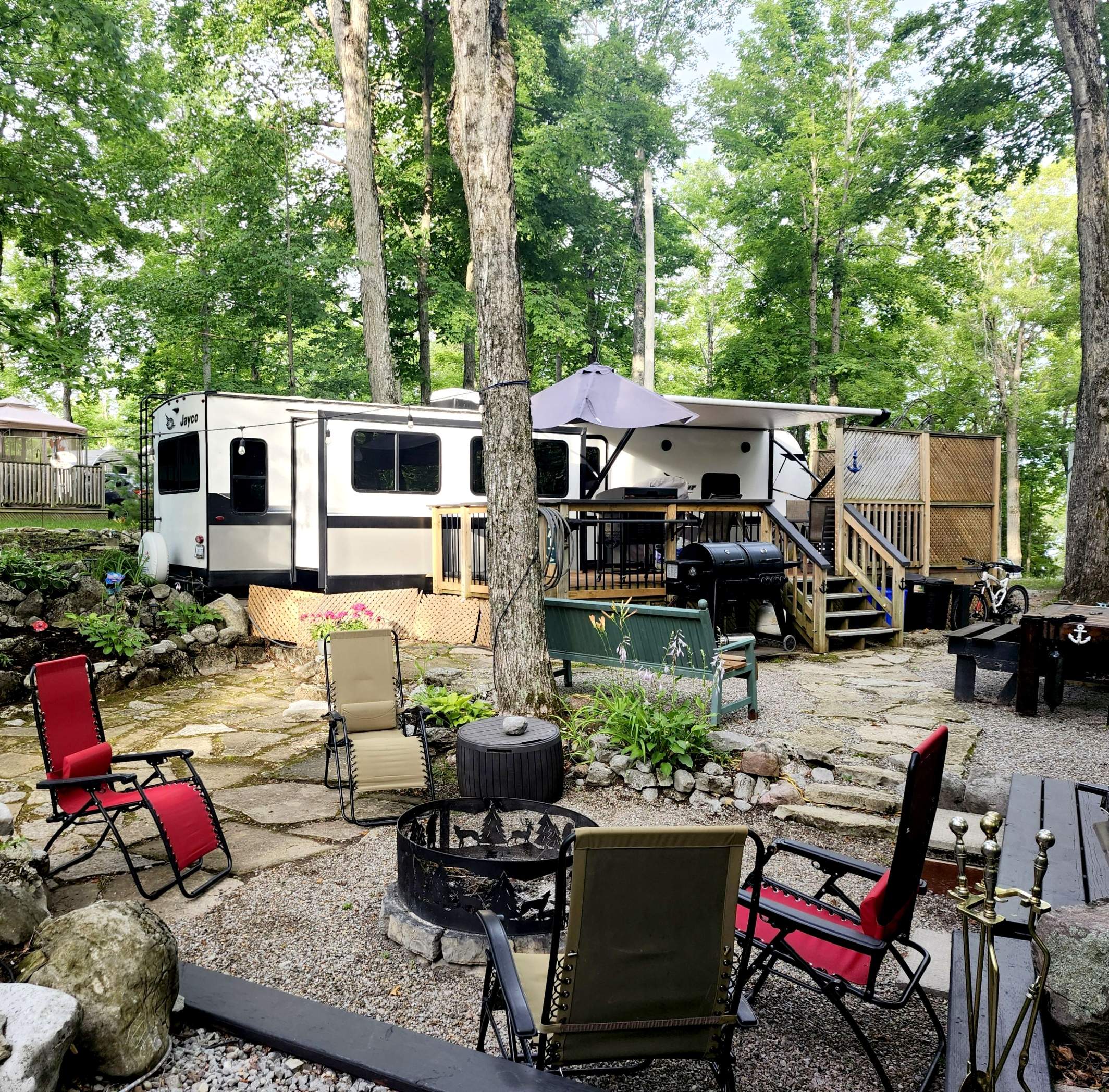 private wooded site with trailer